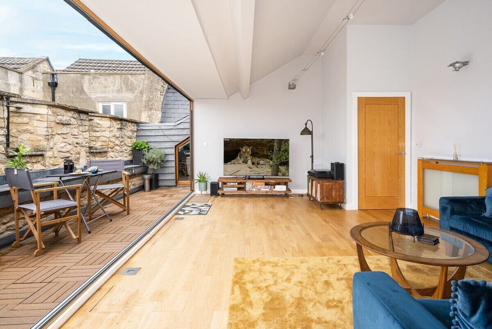 The living room leads out onto a large private terrace area with outdoor furniture for your comfort! 