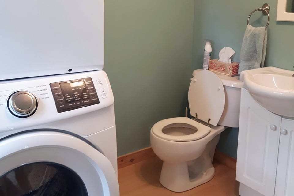 Laundry room/2nd bathroom with toilet and sink.