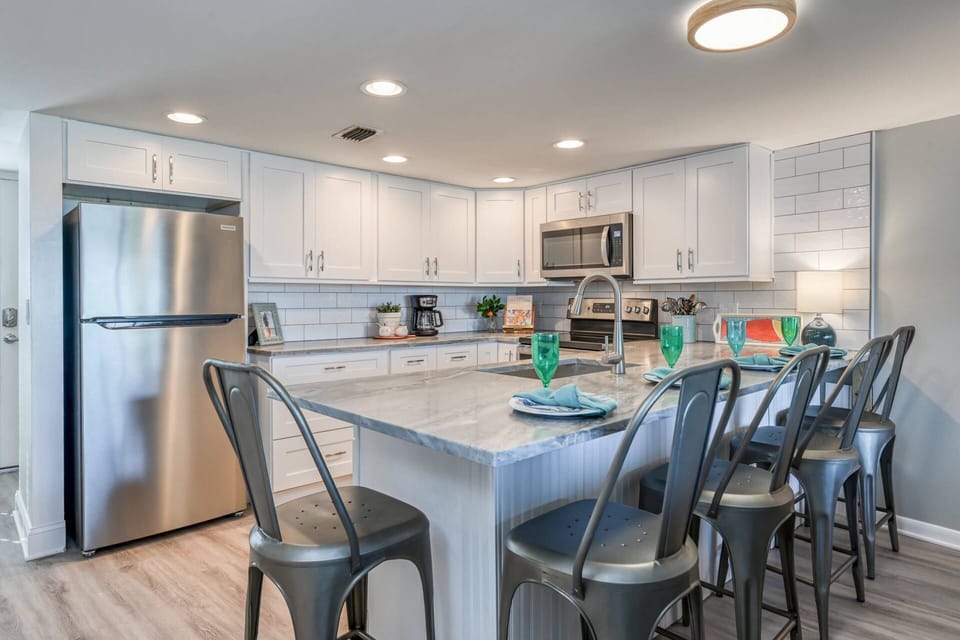 The kitchen is newly renovated and features stainless appliances and a large counter level eating bar.