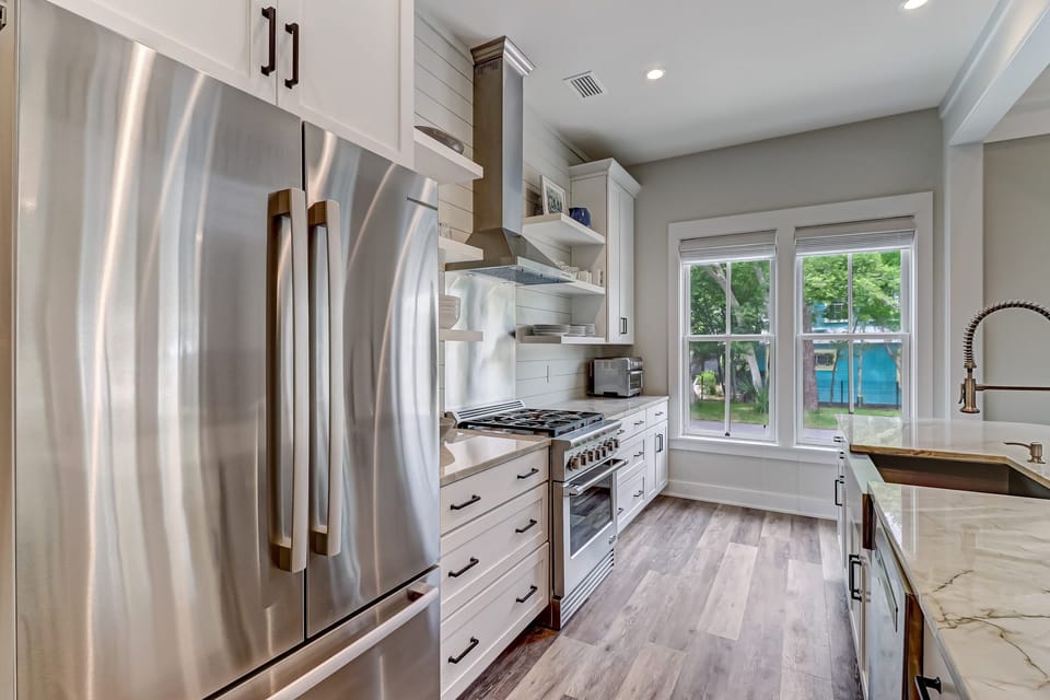 Fully Equipped Gourmet Kitchen with Granite Countertops and Stainless Appliances including a Gas Range