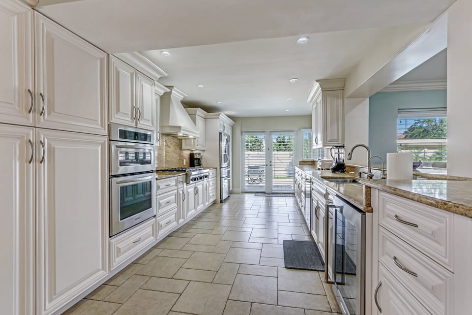 Top-of-the-line kitchen appliances include a built in microwave oven