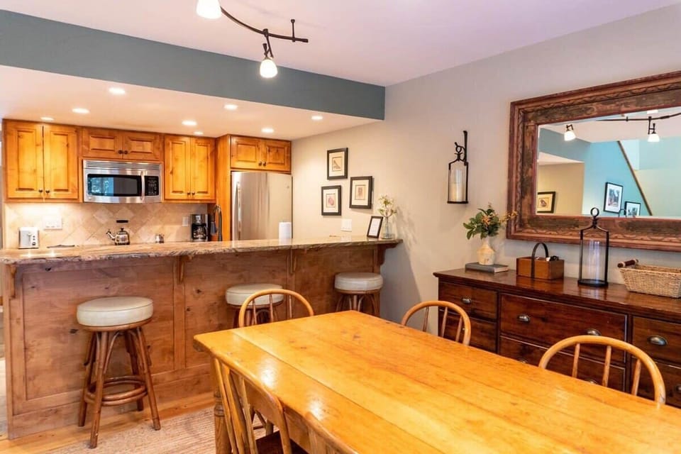 The dining room and kitchen space are connected by a lovely kitchen bar where you will find three bar stools for additional seating in the area.