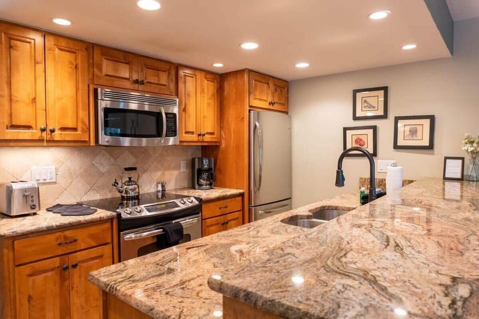 The kitchen boasts stainless steel appliances, beautiful granite counters, and all the cookware needed to make up anything from a big brunch to a crockpot dinner.