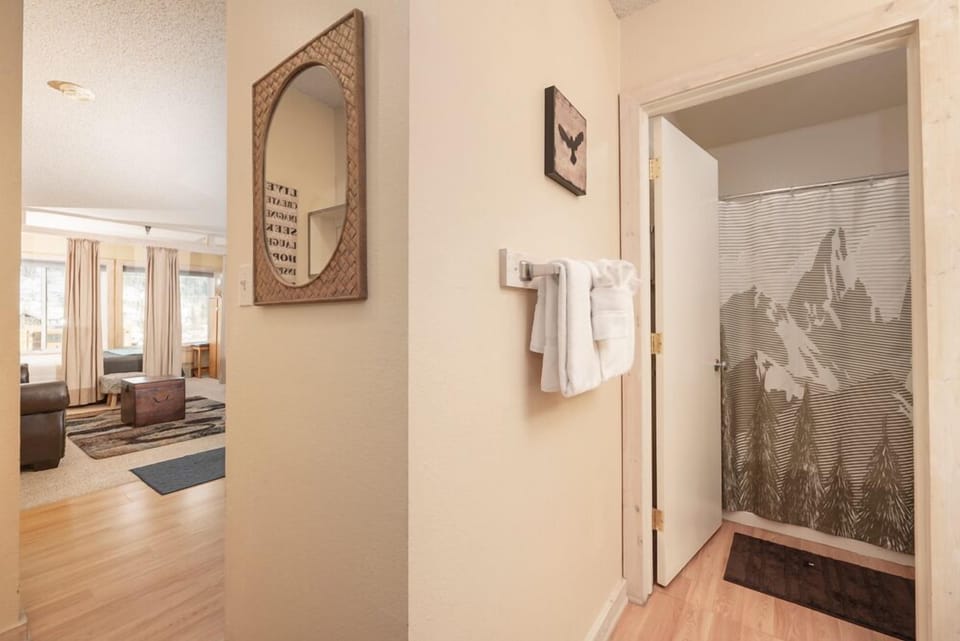 Step inside to find thoughtful details throughout—fresh towels await and the cozy living space beckons beyond.