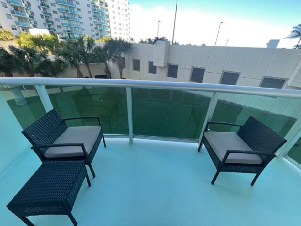 Seating for two with the palm trees swaying the in background on our patio