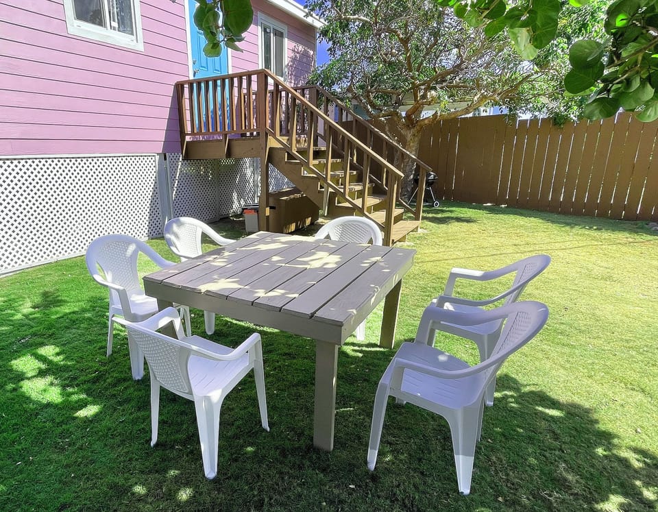 Table and chairs in the shade outside.