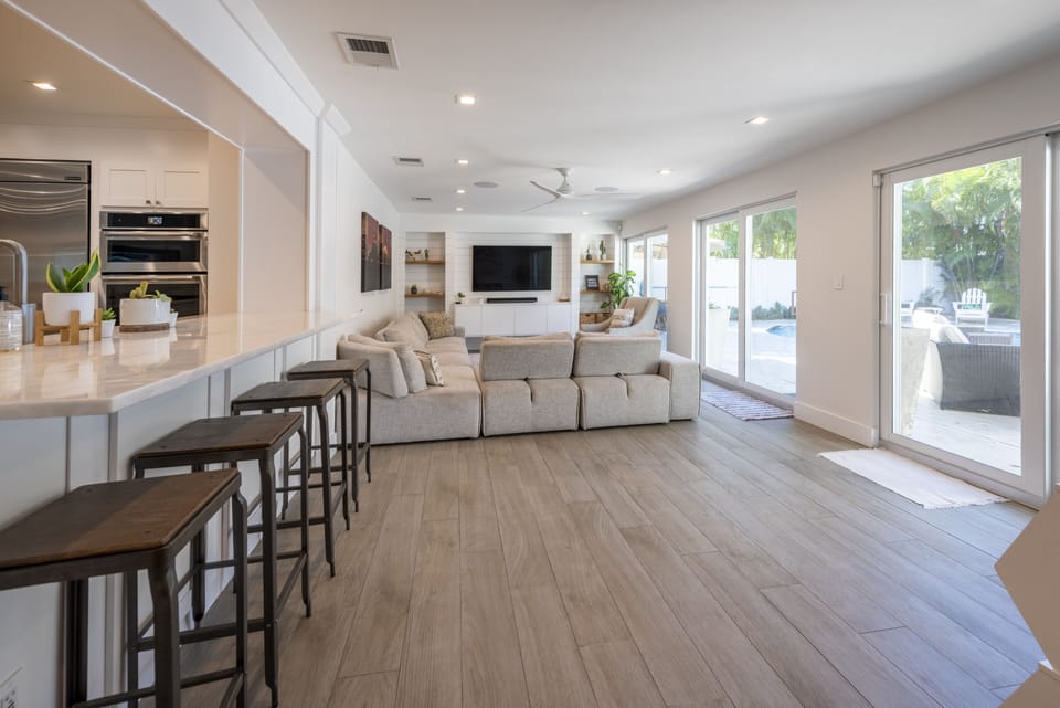 Living room that overlooks the pool deck, plenty of couch space for everyone.