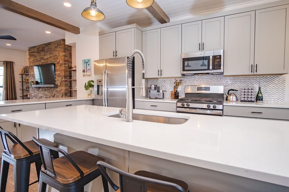kitchen with gorgeous island, stainless steel appliances and large basin sink