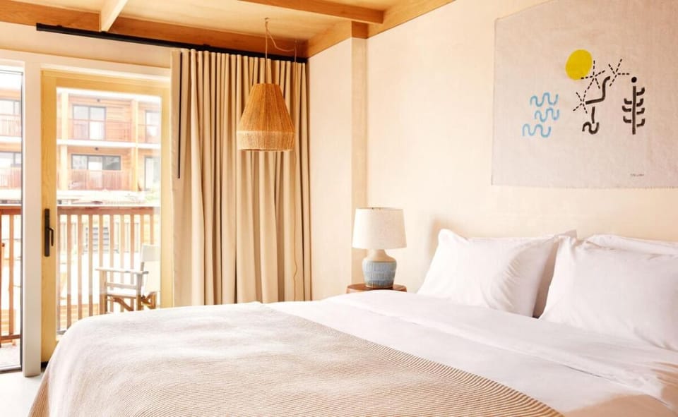 Sink into crisp linens beneath warm wood beams.