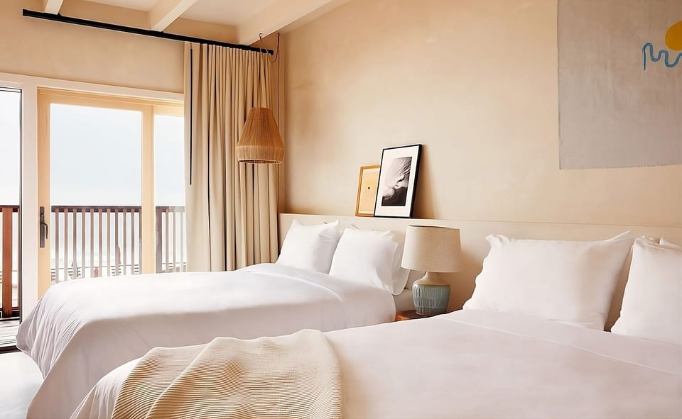 Share bright mornings in twin beds beside the balcony.