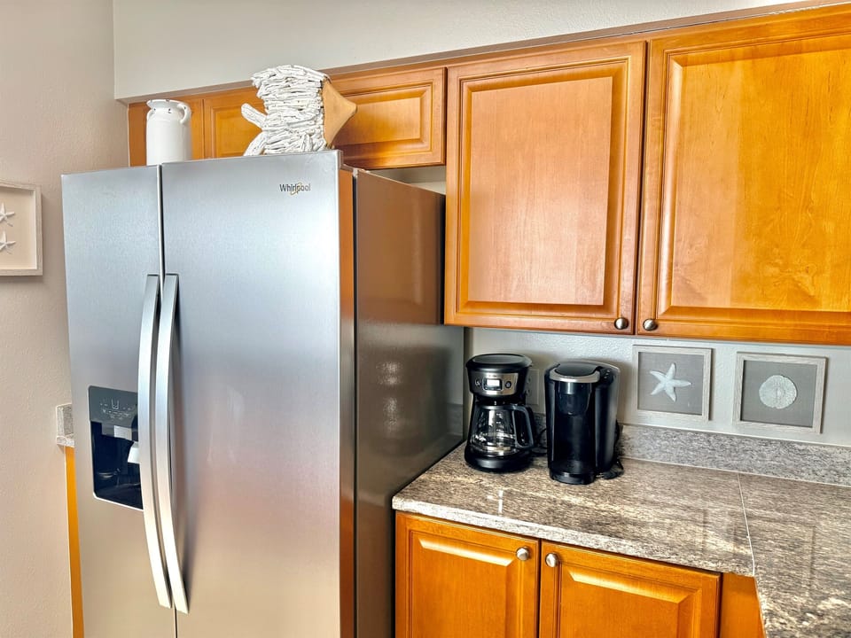 Fully Equipped Kitchen — Granite counters, a brand new 2026 stainless steel refrigerator—Take your cup of coffee to the balcony to enjoy with a regular coffee maker & a K-cup machine!