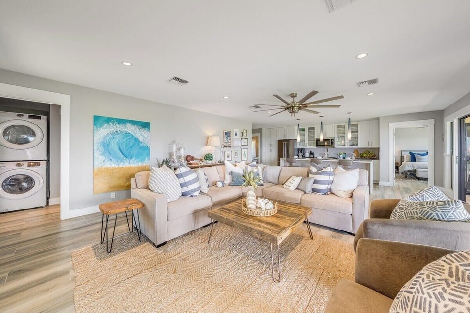Large, beautiful square coffee table and swivel barrel chairs compliment the L-shaped couch
