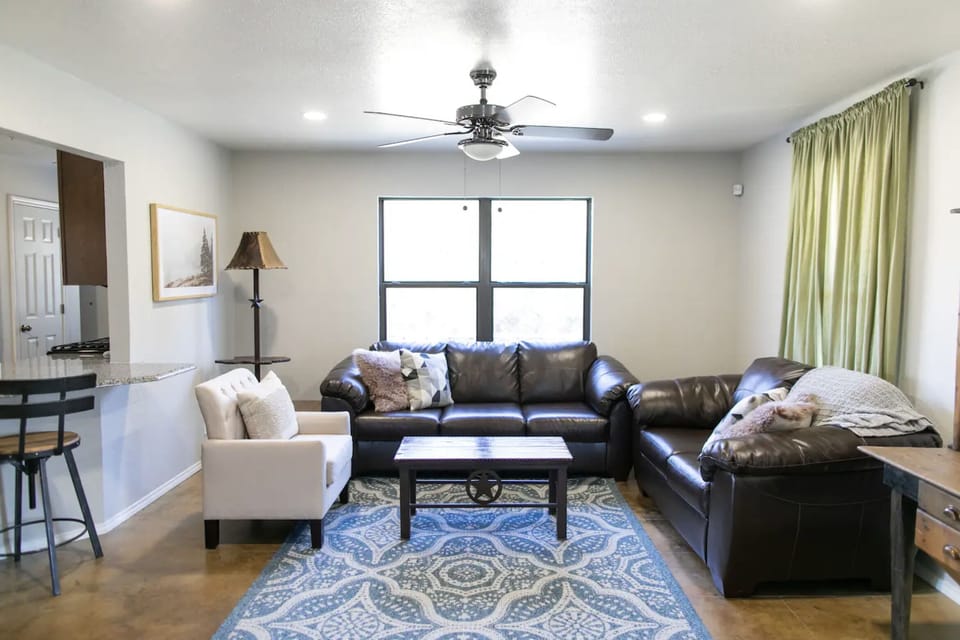 The living room has plenty of space to hang out and watch TV.