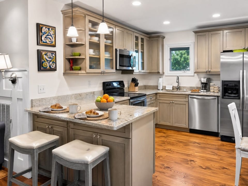 Your fully equipped kitchen awaits with granite counters, stainless appliances, and a cozy breakfast island for morning coffee.