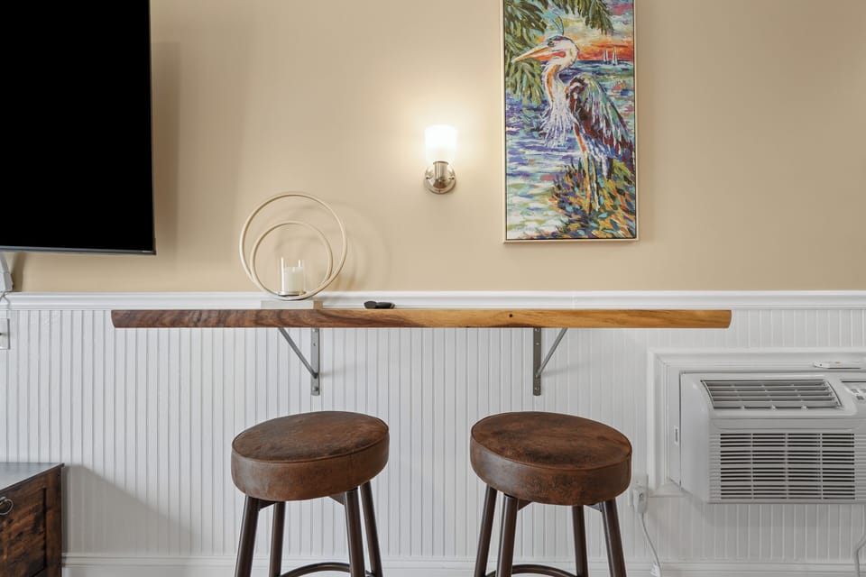 Your perfect spot for morning coffee or evening drinks awaits at this charming breakfast bar with coastal artwork.