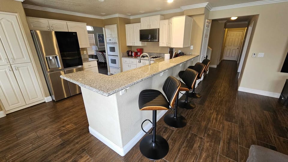 Spacious Kitchen, plenty of dishes and cookware, some spices. 