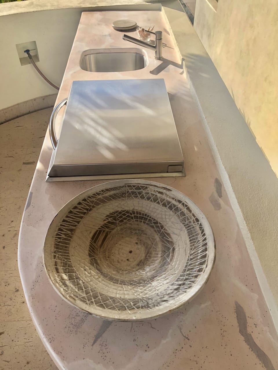 Outdoor cooktop, counter space, and sink area
