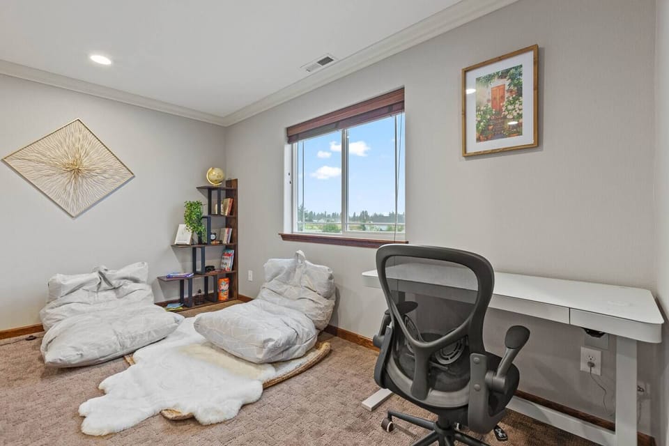 Find your perfect balance of productivity and relaxation in our workspace, featuring a height-adjustable desk and cozy reading nook. Whether you're diving into work or escaping into a good book, this versatile area caters to your every need.