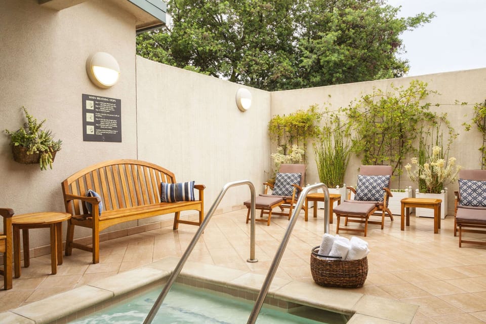 Unwind in the soothing hot tub with serene loungers.