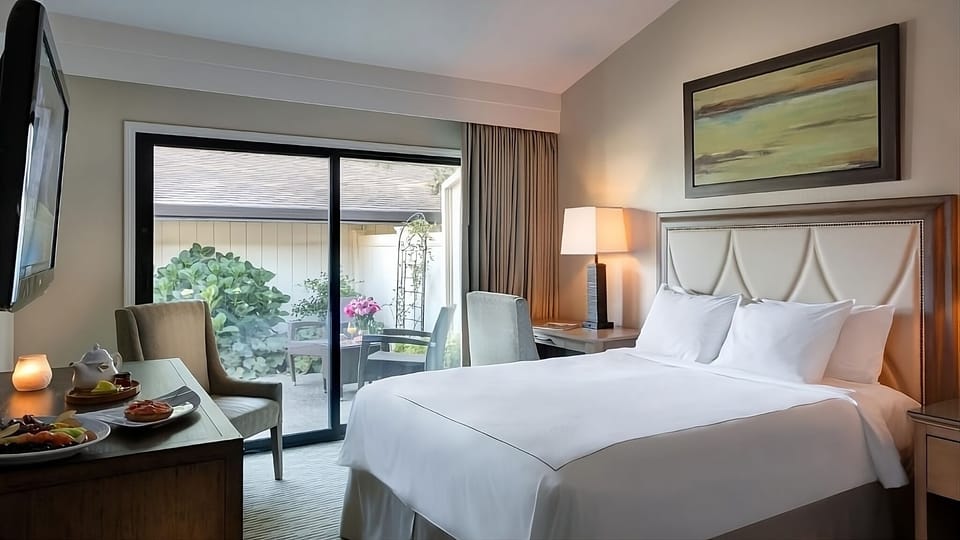 Unwind in crisp linens and step onto the private patio.