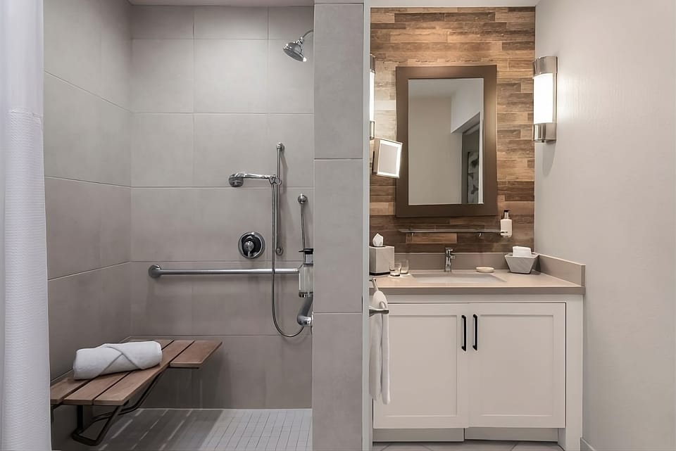 Rejuvenate under a spacious walk-in shower with bench seating.