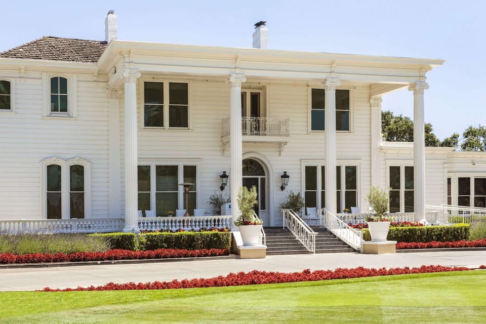 Step up to the iconic veranda and sunlit white facade.