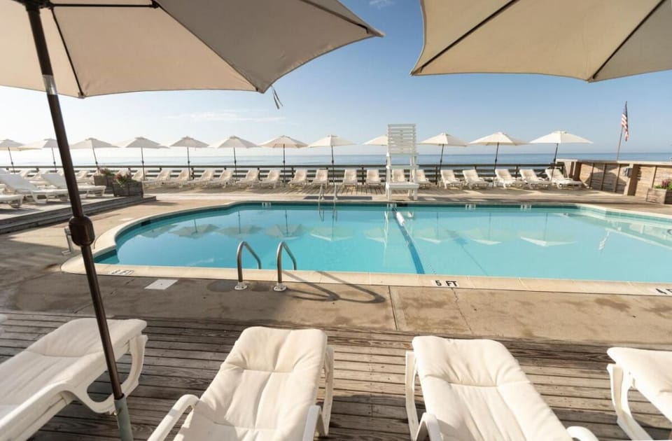 Dive into refreshing blue water with ocean breezes nearby.