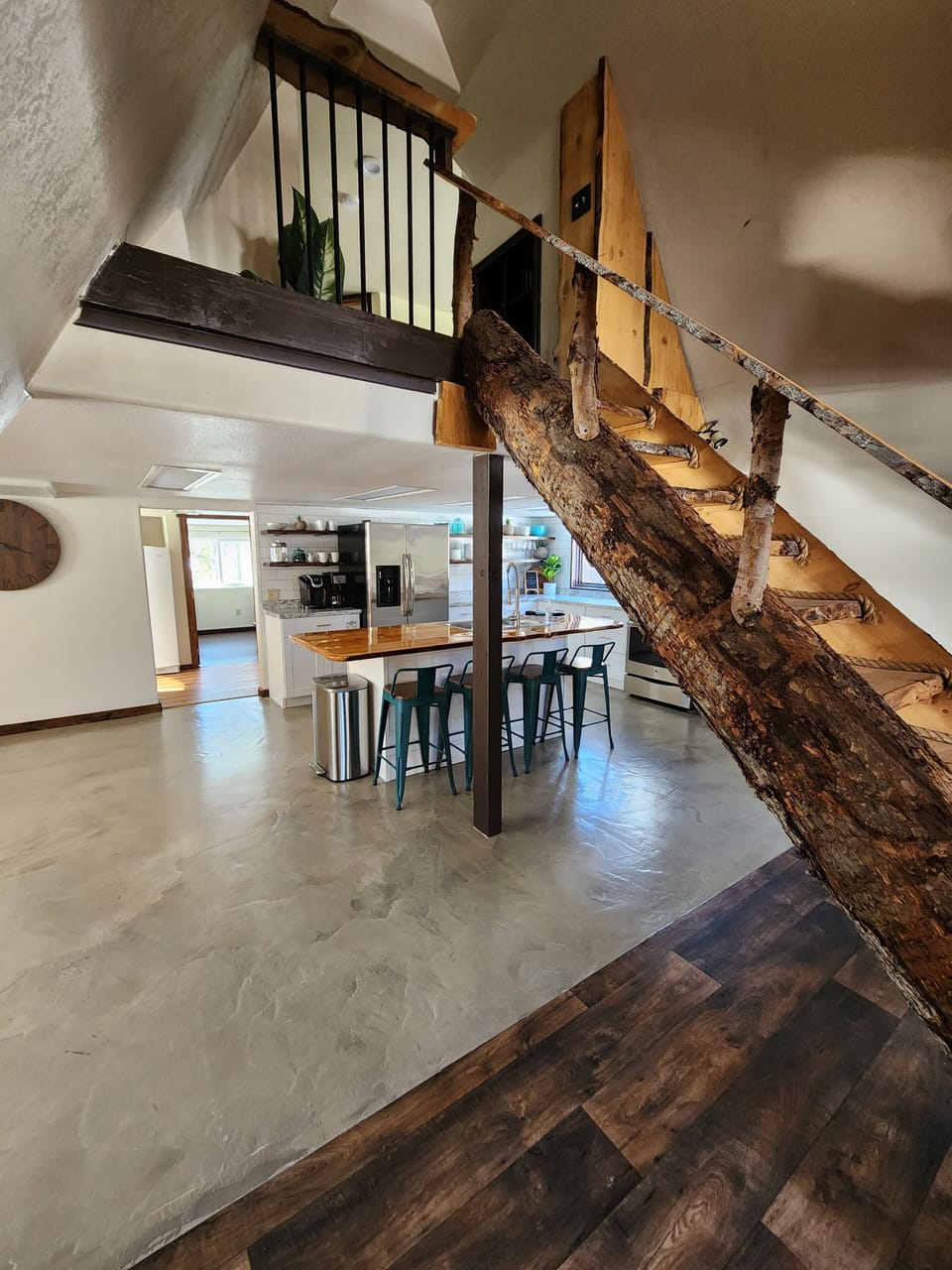 Living room looking into kitchen and up to the loft