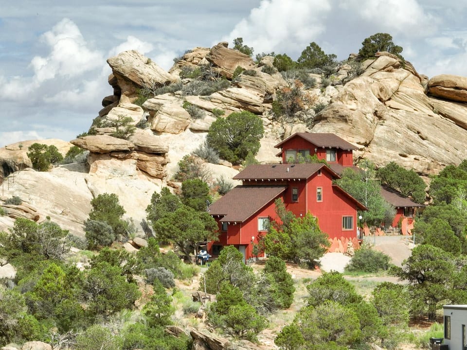 The cottage nestled into an outcropping of sandstone boulders. 



