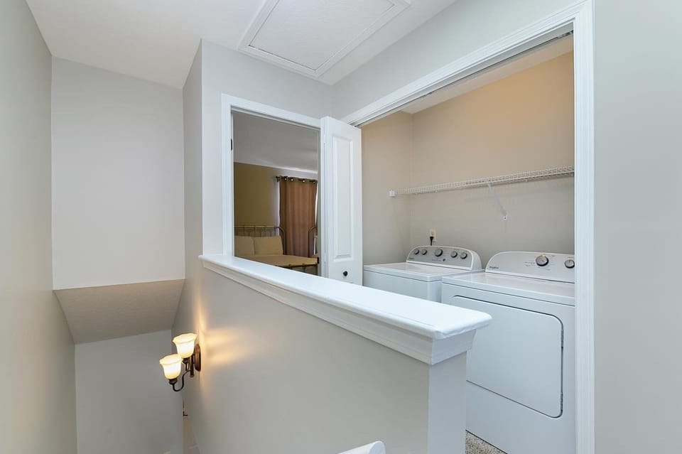 Laundry area upstairs between the two bedrooms