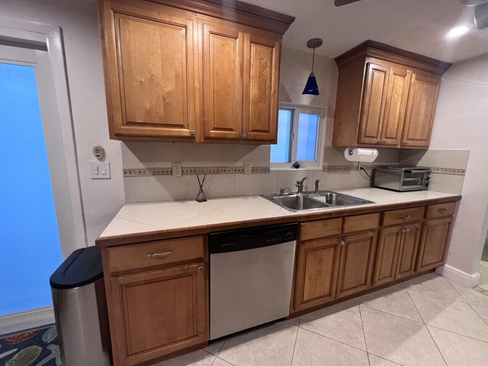 Well appointed kitchen with plenty of dishes, glassware and silverware