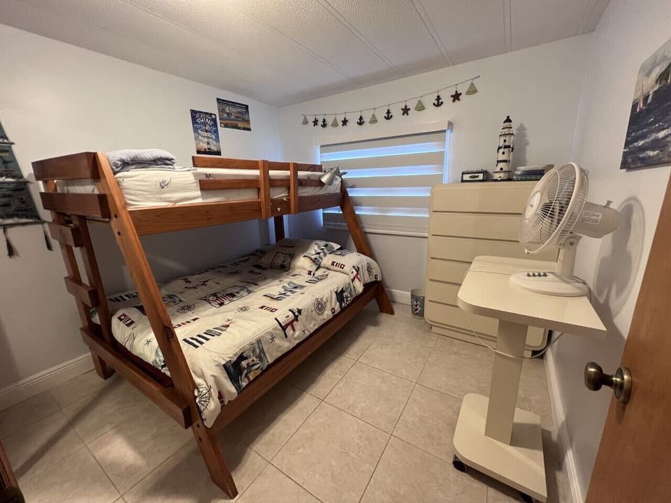Bedroom with twin mattress on top, double on the bottom; mirrored closet doors