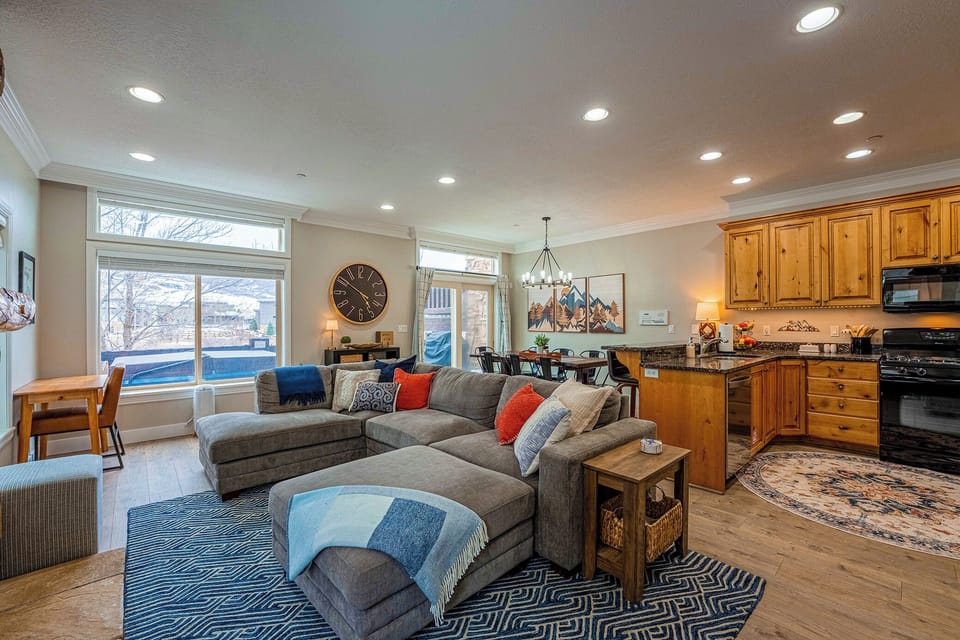 The living room boasts abundant natural light, a welcoming fireplace, and direct access to the balcony.