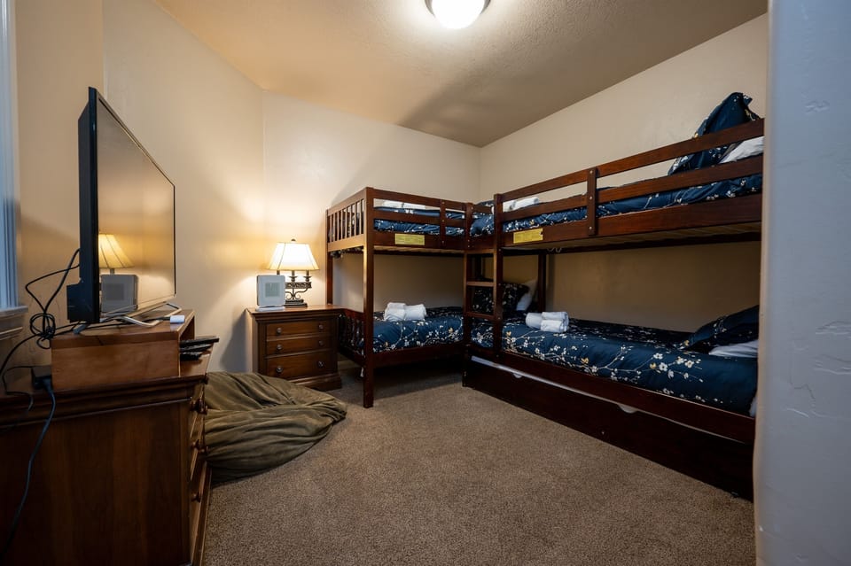 The third bedroom has two sets of bunk beds and a pull-out trundle, offering additional sleeping space if required. A large smart TV is also available in this bedroom.