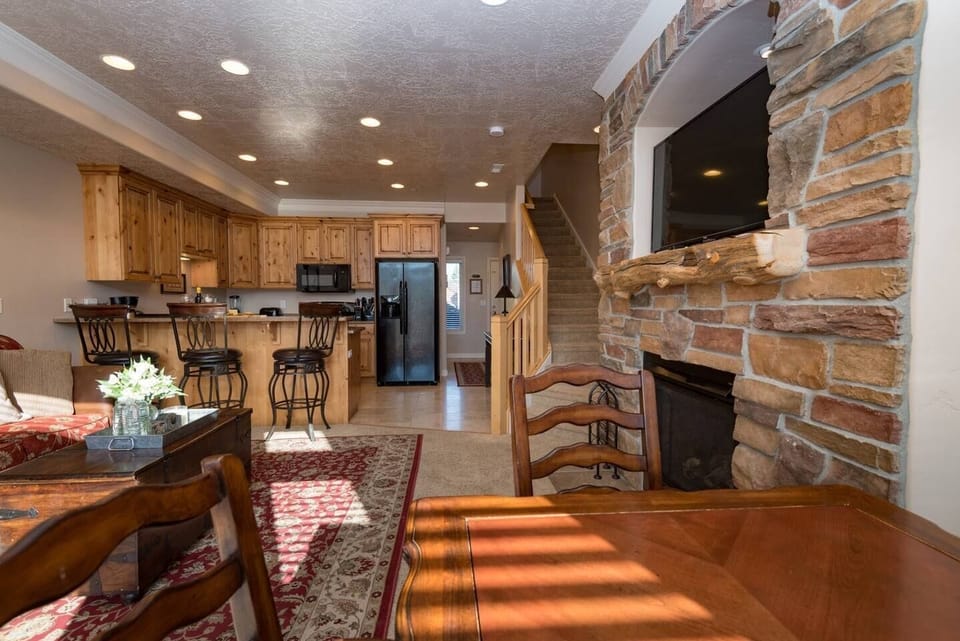 The open-concept living space, complete with a dining area, facilitates effortless conversation with family and friends.
