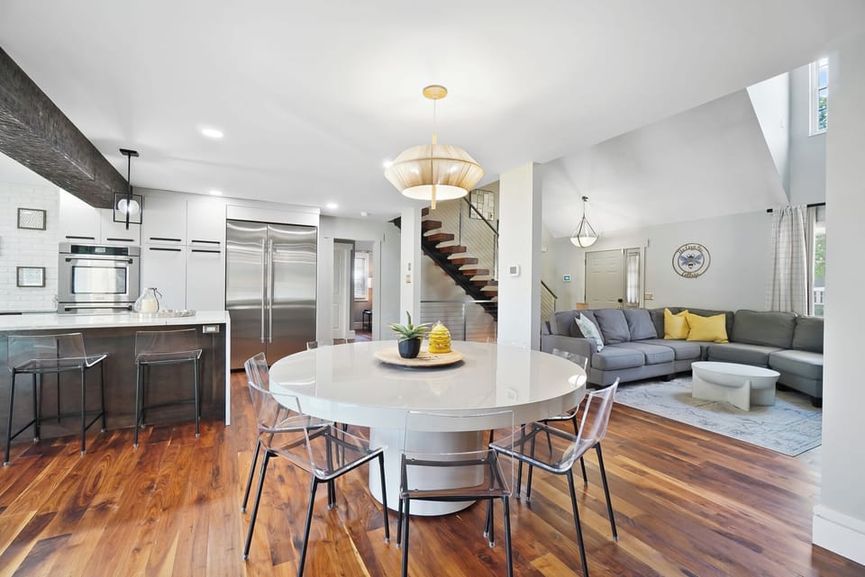 Table seats 8, with 5 bar stools at island.