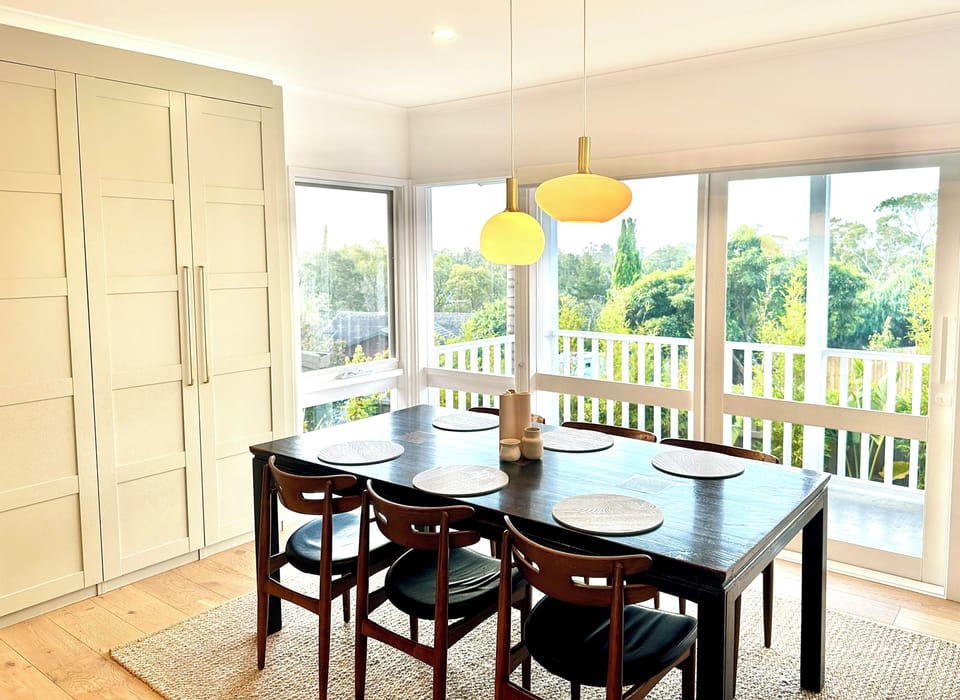 The dining room is light-filled with views over tree-tops