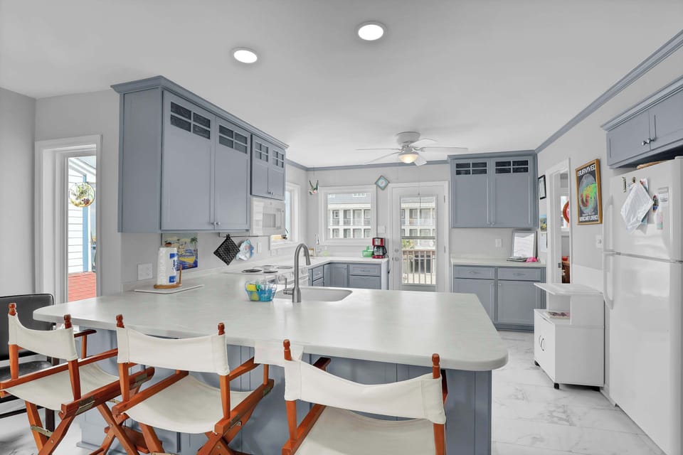 Experience culinary delight in the heart of this townhouse's kitchen, a harmonious fusion of elegance and practicality for your coastal retreat.