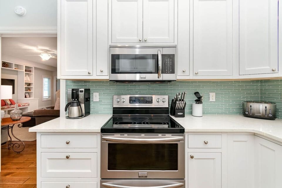 The newly renovated kitchen features a delightful teal tile to balance against the coral tones. We have your coffee ready and available for your!