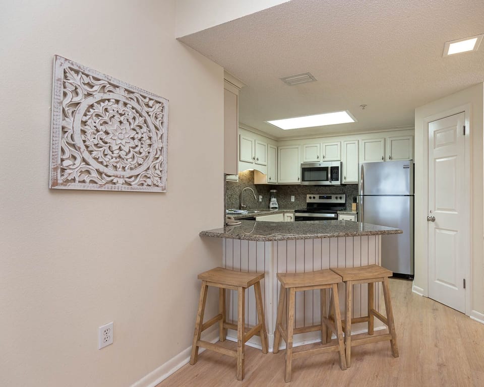 Gather around the inviting kitchen bar with seating, perfect for casual meals and conversation during your stay