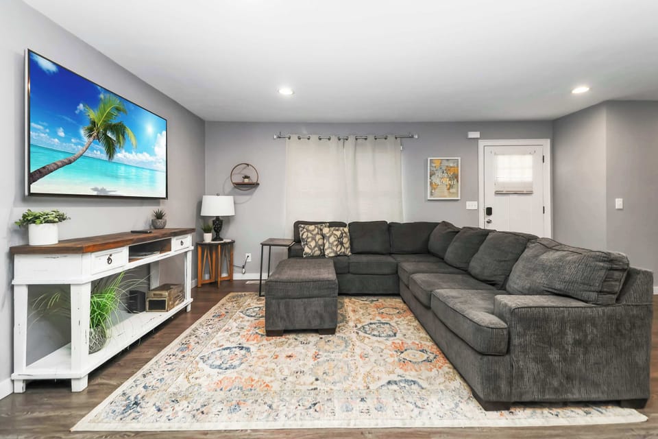  Spacious living room with sectional sofa and smart TV