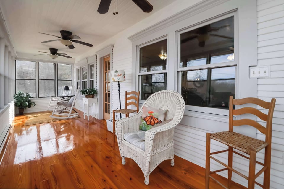 Enjoy conversation and nature in the sun room/porch.