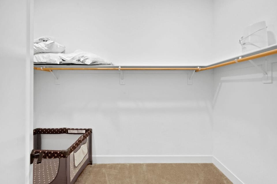 Walk-in closet w/ hanging space & shelving to keep everything organized.