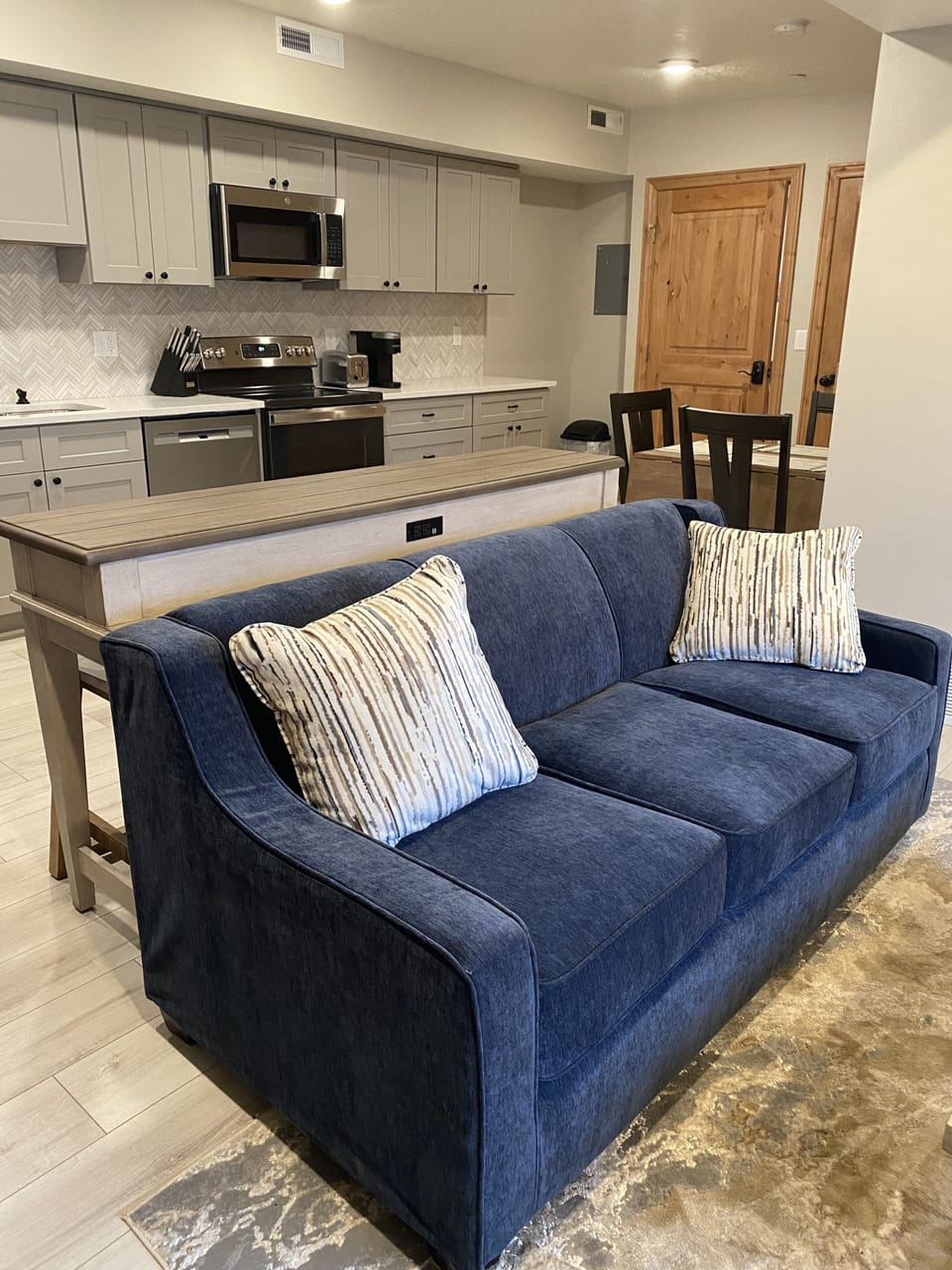 There are two dining tables that seat 3 each. This sofa table has USB ports.