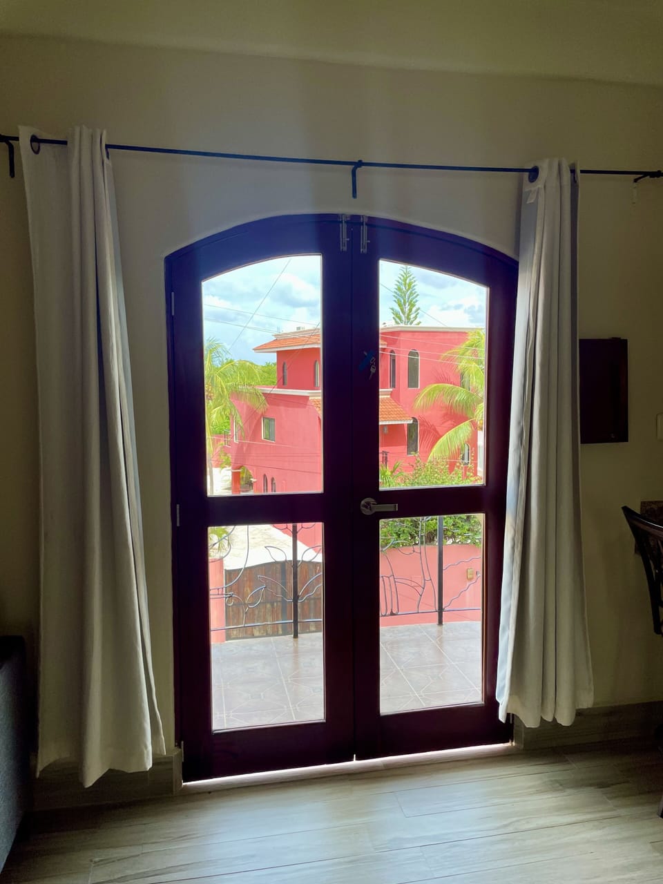 Doors to balcony in master bedroom with king bed and full bath