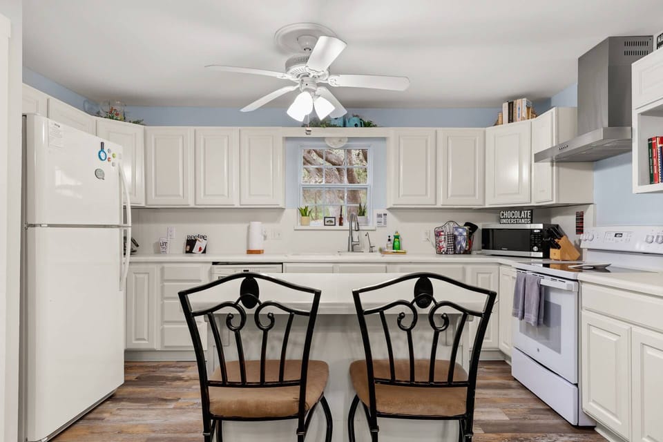 The barstool seating at the kitchen island, creates a cozy spot for conversations and shared moments.