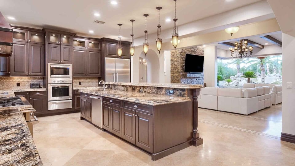 Large full kitchen next to entertainment room w/ two large luxury couches