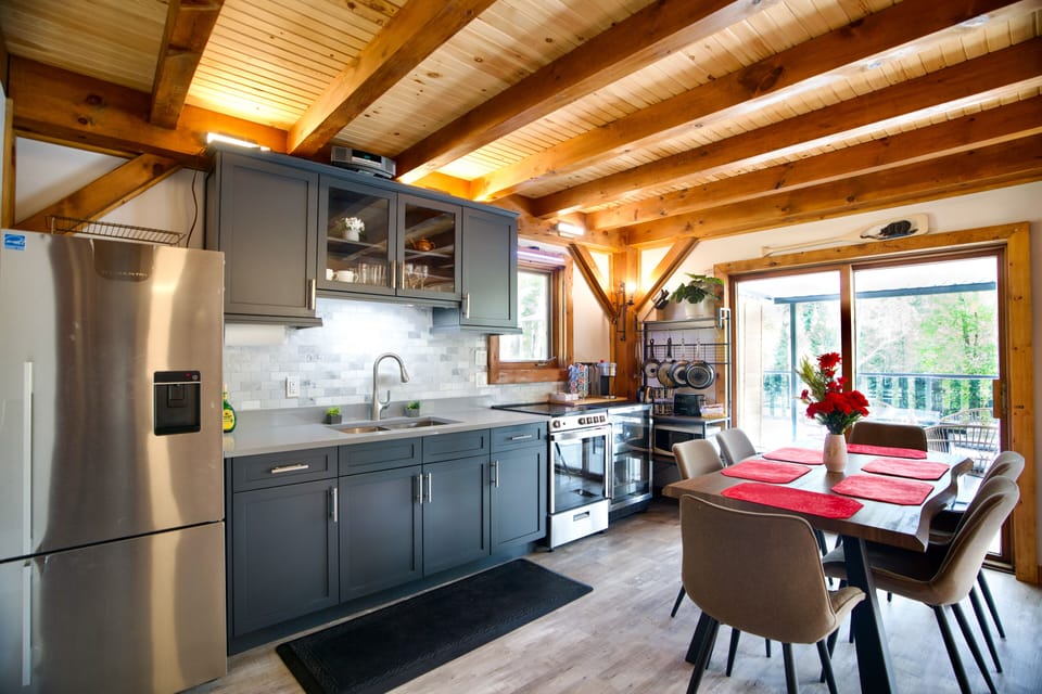 Well-equipped kitchen with refrigerator, stove/oven, and microwave.