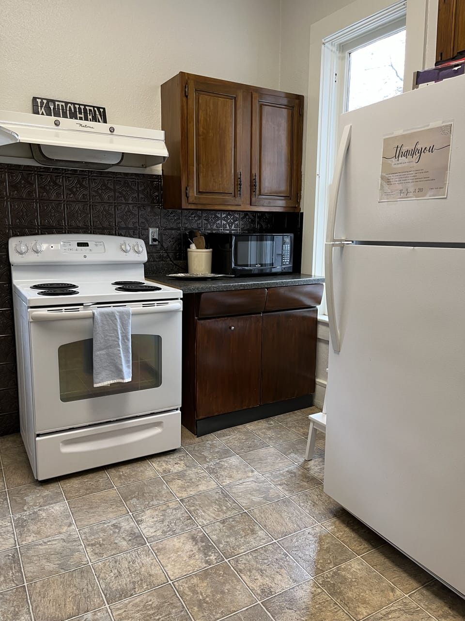 Kitchen includes stove, microwave, and full size refrigerator