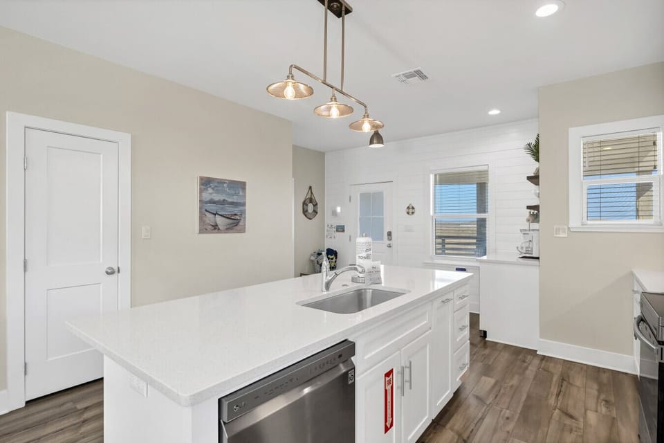 Spacious kitchen island with quartz countertops and bar seating, designed for casual dining and conversation.